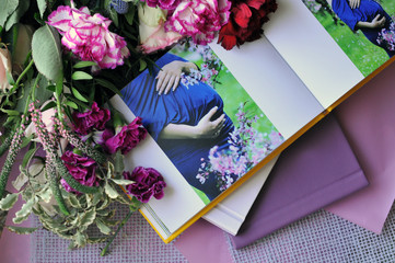 Album in anticipation of a baby decorated with beautiful flowers close-up
