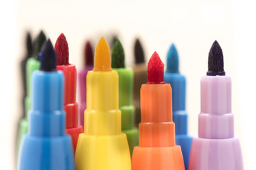 Detail of colorful markers on white background