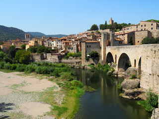 Fototapeta premium View of the Fluvia river and the medieval village of Besalu in Girona - Spain