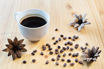 Coffee cup and Coffee beans on a wooden table, selective focus  (detailed close-up shot)