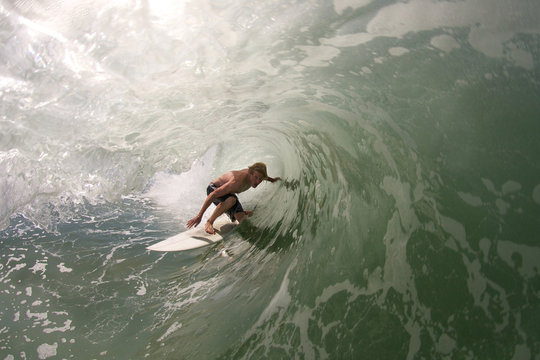 Surfer pulls into tubular wave