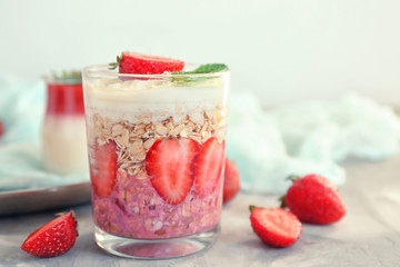 Glass of tasty strawberry dessert on table, closeup