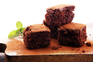 Cake chocolate brownies on wooden background with mint