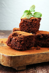 Cake chocolate brownies on wooden background with mint