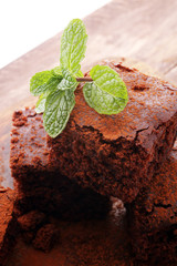 Cake chocolate brownies on wooden background with mint