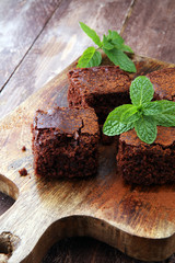 Cake chocolate brownies on wooden background with mint