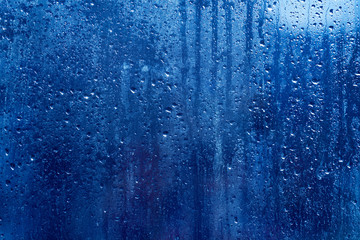 drops on glass , blue background