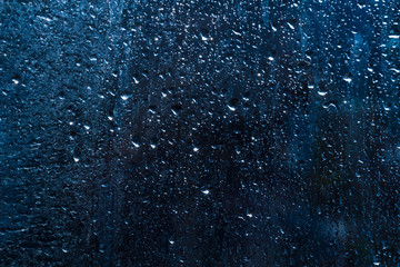 drops on glass , blue background