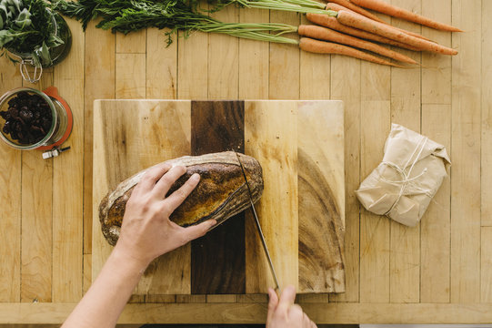 Slicing a loaf of bread for a meal preperation