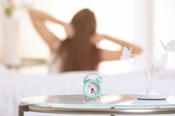 Alarm clock on table in bedroom