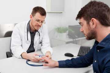 A doctor consulting with a pulse oximeter