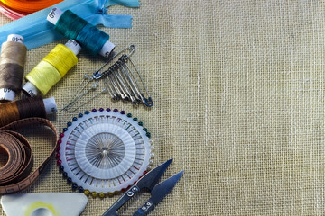 Scissors, coils of multi-colored threads, centimeter, pins with needles, sewing chalk.