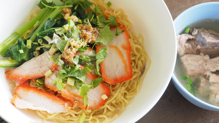 Egg noodle Cantonese recipes with BBQ pork and pork bone soup close up full frame