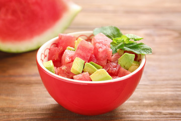 Fresh salad with watermelon on table