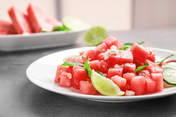 Fresh salad with watermelon on table