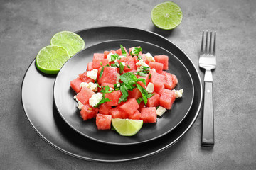 Fresh salad with watermelon on table