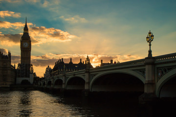 Sunset at the Big Ben clock tower and the bridge in London, England