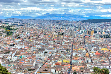 Obraz premium High view of Quito, from the Panecillo hill, on a cloudy and overcast afternoon. Quito, Ecuador.