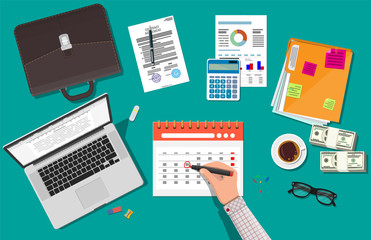 Paper spiral wall calendar. Hand with pen