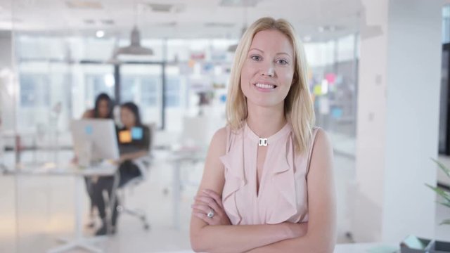  Portrait of attractive smiling businesswoman in creative office