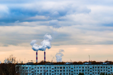 Smoking pipes of thermal power plant on sunset