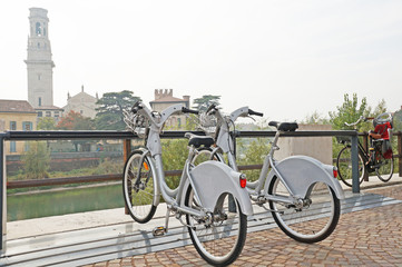 Fototapeta premium Two bicycles are parked in a beautiful city. Bicycles on the background of the cityscape.