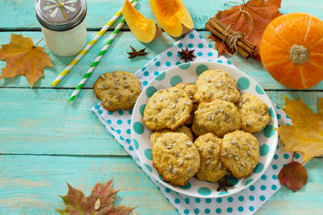 Breakfast table with pumpkin scones and milk on a kitchen wooden table.