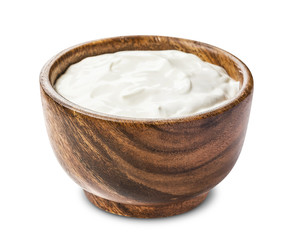 Sour cream in wooden bowl isolated on white background