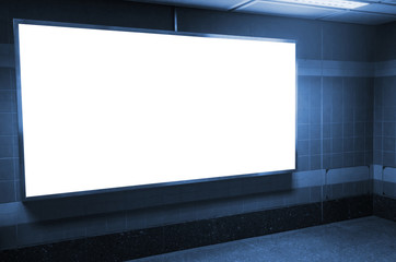 blank advertising billboard or light box with copy space for your text message or media content in subway train station or airport, information board, commercial, marketing concept, blue tone color