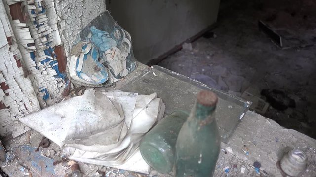 Chernobyl, Ukraine - 17th of June 2017: Visit to Zalesye village in Chernobyl zone - 4K Old picture and rubbish on window sill in abandoned village house