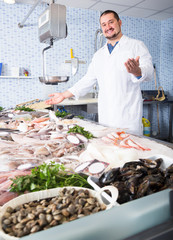 mature man standing near fish counter