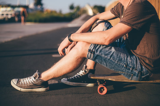 Men sitting on a skateboard