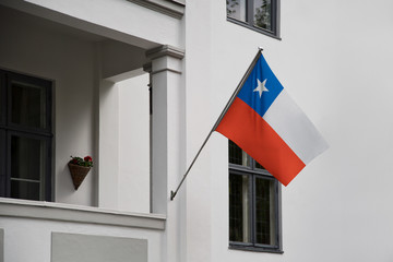 Chile flag.  Chilean flag displaying on a pole in front of the house. National flag of Chile waving...