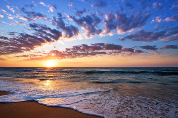 Brilliant ocean beach sunrise. Dramatic sky.