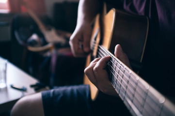 Guy playing on acoustic guitar