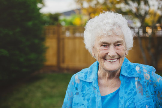 Happy portrait of old - elderly - woman in backyard