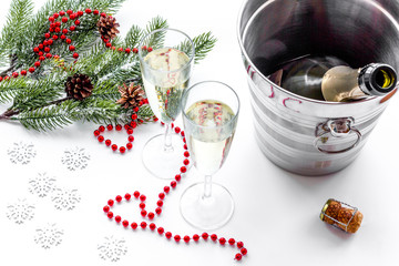 New Year 2018 background. Champagne in bucket, glasses with beverage, spruce branch and decoration on white background