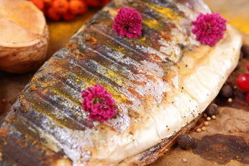 Roasted grilled fish, cheese, honey, rowan, kalina, lemon slices, baked potatoes, pink flowers, turmeric and mustard seeds on vellum paper in retro style
