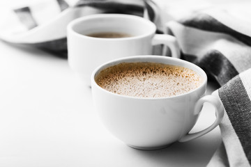 Two cappuccino on a white table. Morning coffee.