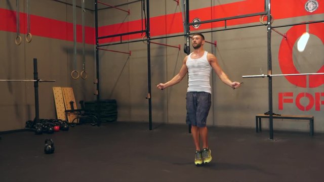 Man Working Out Jumping Rope in a Crossfit Gym