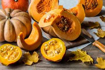 Sliced pumpkin with seeds on a wooden background. Close-up