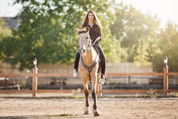 Portrait of young woman riding a horse. Dreaming to become a stallion manager to move from office to farm.