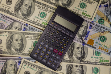Fototapeta premium Calculator on the American one hundred dollar bills background