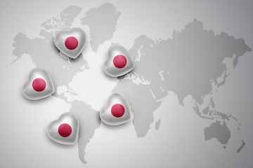 five hearts with national flag of japan on a world map background
