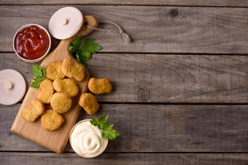 Chicken nuggets on wooden background