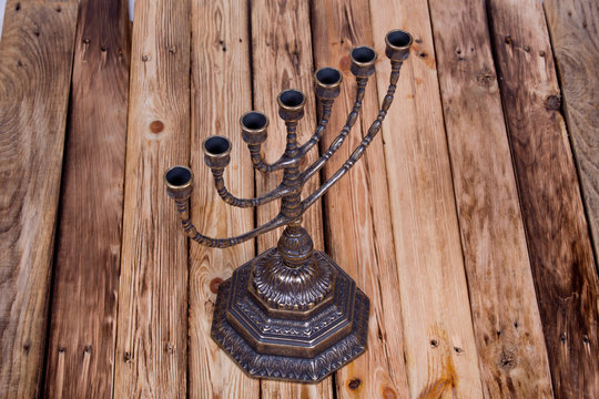 Ancient ritual candle menorah on a wooden table