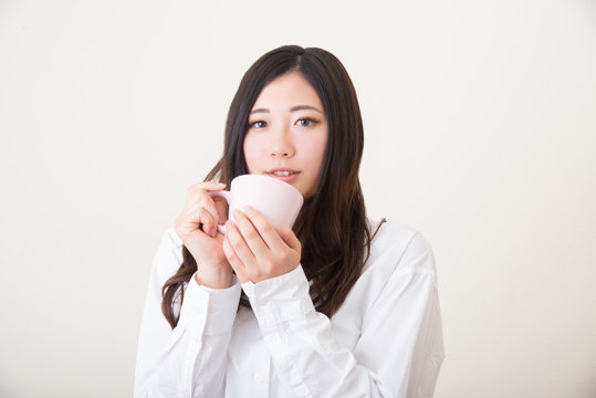 young asian woman drinking tea
