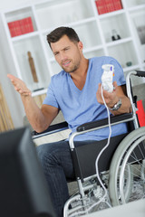 Fototapeta na wymiar disabled man on the wheelchair holding a joystick