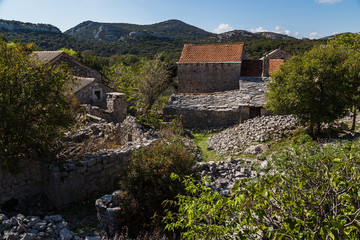 Fototapeta na wymiar Piles of rubble where buildings once stood at Donja Nakovana
