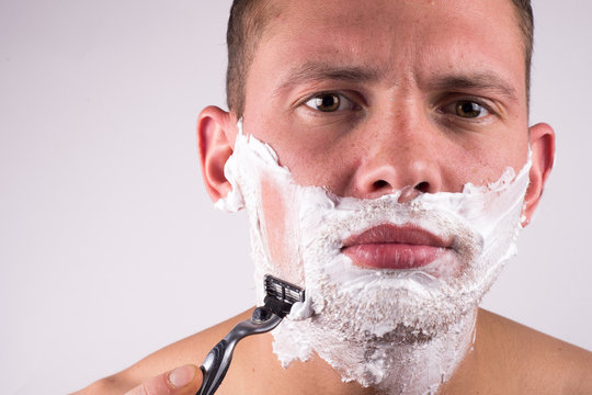 Close-up Of Handsome Young Man Shaving Face